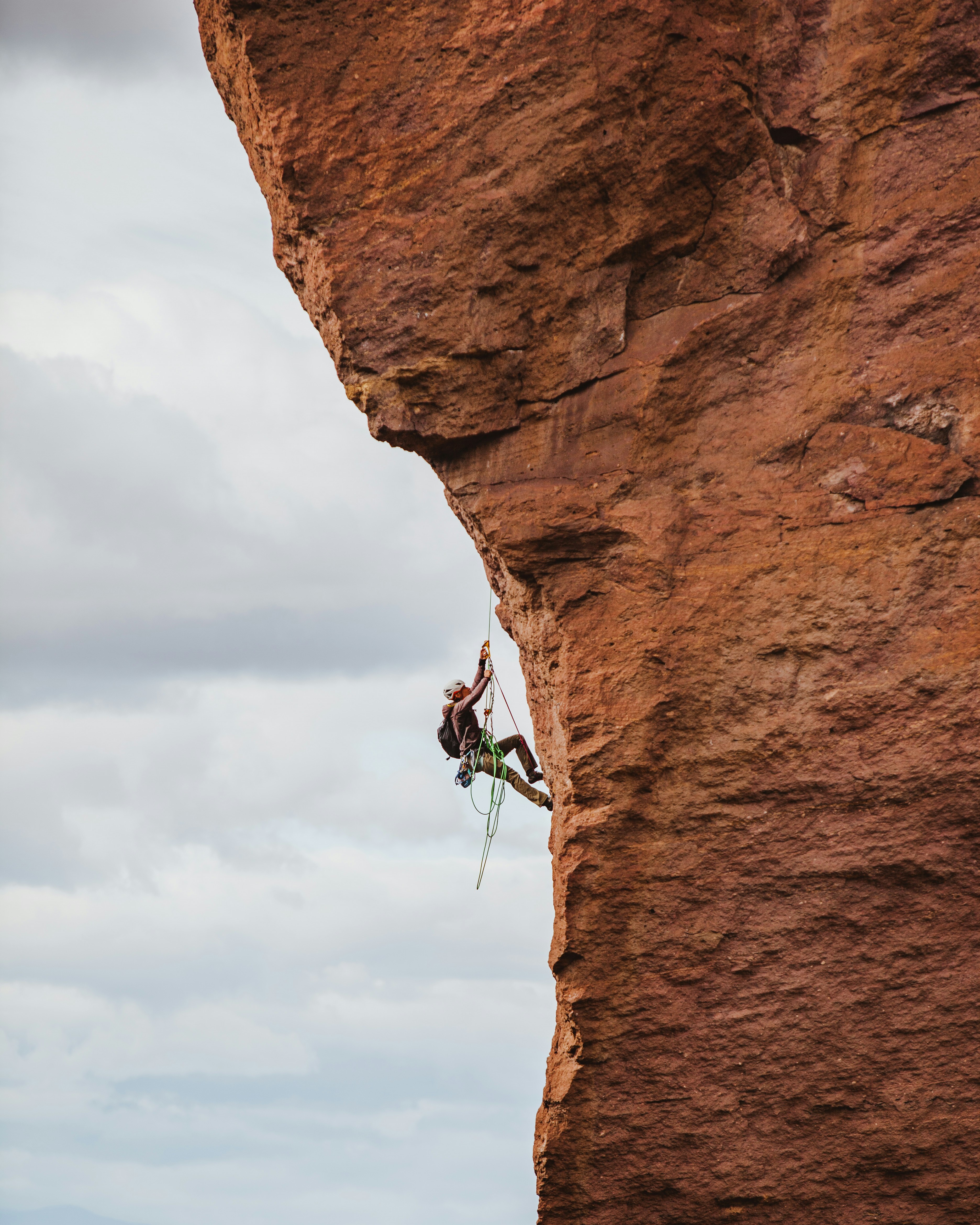 Climber ascending rock face